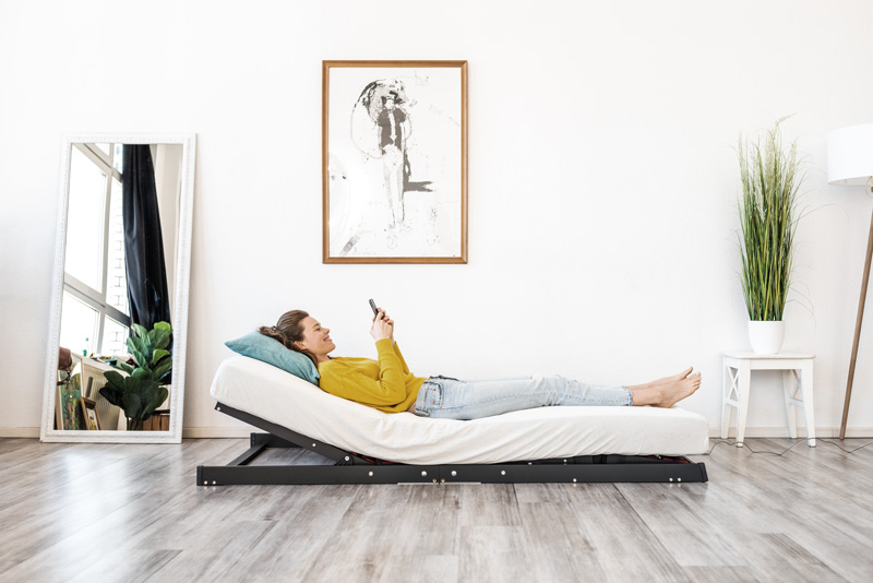 Woman lying on a mattress on the floor with Cosy2Go angled